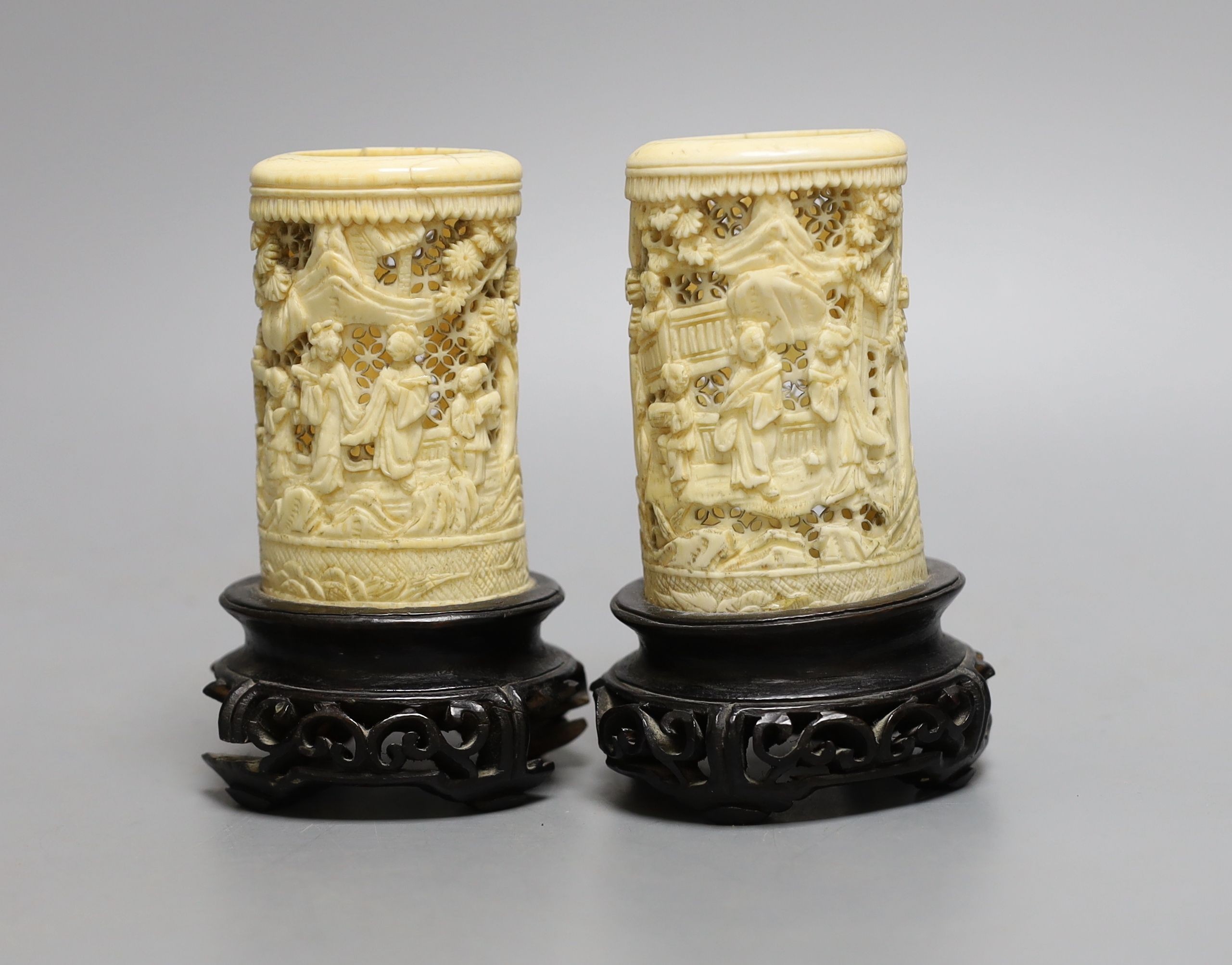 A pair of 19th century Chinese carved ivory brushpots on wooden stands - 12cm tall (including stands)